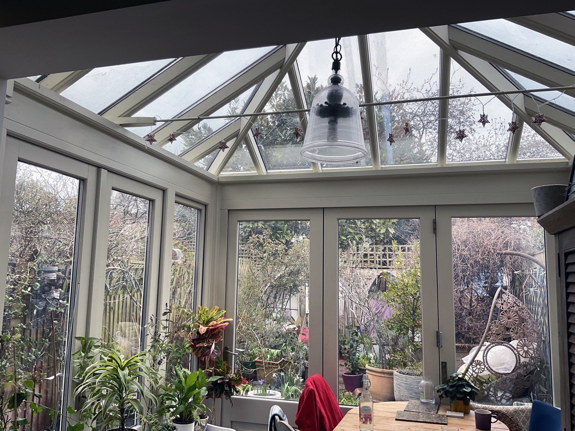 N Clark Window Cleaning cleaning second-floor windows by hand on a ladder in Camden — streak-free finish